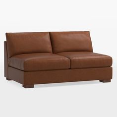 a brown leather couch sitting on top of a white floor