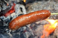 a hot dog is being cooked over an open fire