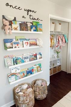 a child's room with bookshelves and baskets on the floor in front of it