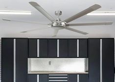 a ceiling fan in a kitchen with black cabinets