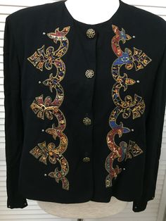 "Vintage Carole Little short front button black and paisley long sleeve jacket Made in USA preppy to boho jacket from famed 1980's designer. The paisley is outlined with gold thread, the buttons are gld tone and the sleeve cuffs are trimmed with small gold tone beads- the little details that make Carole Little designs s unique and collectible. Shoulder 16\" w/ removable shoulder pads Chest 42\" buttoned Length 21\" Sleeve 22\"" Vintage Embroidered Blazer For Fall, Fitted Patterned Long Sleeve Outerwear, Fitted Bohemian Long Sleeve Blazer, Summer Cotton Tops, Vest Blouse, 1980s Design, Boho Jacket, Pullover Mode, Little Designs