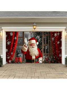 a christmas scene with santa clause waving out the window