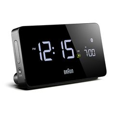 the alarm clock is black and has two different numbers on each side that read 2 20 pm