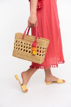 A fun twist on your old beach bag, elevated with a hand woven design. Both the bright handle and pom take this bag to the next level! Details: Size 13w x 9.5h 100% Natural Rattan with Jute Handle. Colorful tassel. Summer Beach Bag With Tassels For Shopping, Summer Shopping Straw Bag With Tassels, Summer Straw Bag With Tassels For Shopping, Rectangular Beach Bag For Summer Outings, Playful Summer Beach Bag For Vacation, Playful Beach Bag For Summer Vacation, Playful Rectangular Beach Bag For Summer, Summer Straw Shopping Bag With Tassels, Rectangular Summer Beach Bag With Tassels