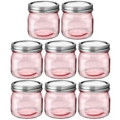 six pink glass jars with silver lids