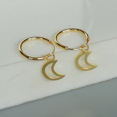 A PAIR of 12 mm sterling silver hoops. Comes with a delicate crescent moon charm. Charm can be used with a neck chain anklet or bracelet. Dimensions: Hoops: 12 x 1 mm Crescent: 22 x 3.5 mm Drop length 15 mm These earrings are made of 925 hypoallergenic sterling silver dipped in gold. Price listed is for ONE PAIR Can be packaged in a gift box. I can include a personal message from you if needed You are welcome to contact me at... bhavnakwintra1956@gmail.com For more beautiful pieces from my shop, Celestial Hypoallergenic Hoop Earrings For Everyday, Celestial Hoop Earrings Tarnish Resistant, Celestial Style Hypoallergenic Hoop Jewelry, Celestial Hypoallergenic Hoop Jewelry, Celestial Hypoallergenic Round Hoop Earrings, Everyday Celestial Hypoallergenic Hoop Earrings, Everyday Hypoallergenic Celestial Hoop Earrings, Celestial Tarnish Resistant Hoop Earrings, Celestial Small Hoop Earrings As Gift