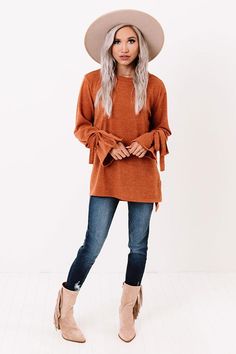 The coziest sweater has just arrived! Perfect for everyday, but with a hint of 'flare,' the pumpkin colored 'Winter Weather Shift Top' is everything you could want and more! This sweater features a split high-low hem, with more coverage in the back, ultra soft and stretchy fabric, and long sleeves that flare at the wrist and are accented by ties! Impressions Online Boutique, Winter Weather, Women Clothing Boutique, Top Sales, Cozy Sweaters, Online Boutiques, Stretchy Fabric, Online Womens Clothing, Boutique Clothing