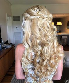 the back of a woman's head with long blonde hair and a tiara