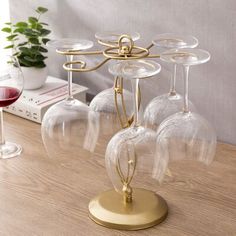 four wine glasses sitting on top of a wooden table