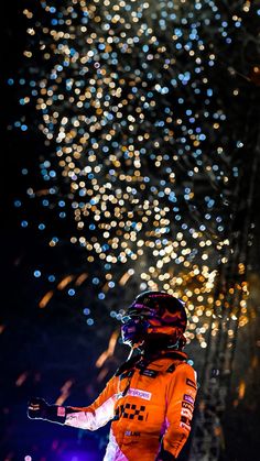 a person on skis in the snow with fireworks behind them and lights all around