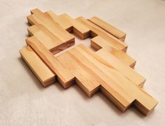 several pieces of wood laid out on the floor to be cut into squares and rectangles