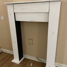 an old white fireplace with no mantle in the corner