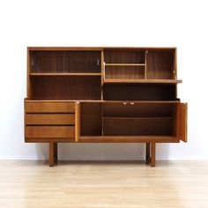 a large wooden cabinet with drawers and shelves