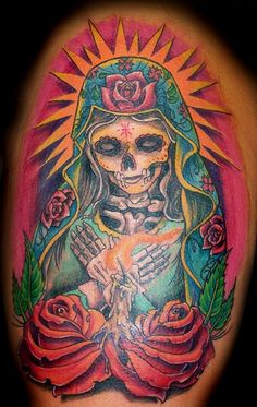 a tattoo with a woman holding a baby in her arms and roses around her neck