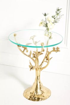 a glass table topped with a gold tree