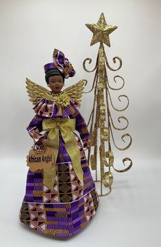 "Celebrate pride and beauty with our unique AFRICAN ANGEL Tree Topper and give your loved ones the gift of representation that reflects images of you and your family. Our Beautiful Angel Tree Topper add the perfect final touch to your Christmas, Kwanzaa and Home Decorating. (Please see listings for other available styles, as seen in the collection photos: Magenta, Baby Blue, Pink and Blue Metallic gold colors). OPTIONAL: Clear Display Case Let me tell you more about this AFRICAN ANGEL (Dressed i African Angel, Mannequin Christmas Tree, Porcelain Angel, Christmas Tree Angel, Metallic Gold Color, Angel Tree Topper, Angel Dress, Angel Tree, Kwanzaa