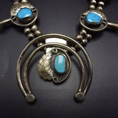 "VINTAGE NAVAJO SQUASH BLOSSOM NECKLACE DESCRIPTION: This classic Navajo squash blossom necklace features 13 specimens of brilliant blue Morenci turquoise. The gemstones are secure in micro-serrated bezel, on a foundation of heavy gauge vintage sterling silver. Applied leaves flank each of the high blue gemstones. This necklace will be a valuable addition to your collection of fine vintage Native American jewelry. MEASUREMENTS: Necklace measures 32\" end to end Naja measures 2 1/2\" x 2 1/2\" Be Vintage Blue Rectangular Jewelry, Turquoise Vintage Jewelry With Vintage Charm, Vintage Blue Turquoise Necklace Collectible, Collectible Vintage Blue Turquoise Necklace, Retro Turquoise Jewelry For Collectors, Retro Turquoise Jewelry For Collectible, Retro Turquoise Jewelry Collectible, Vintage Turquoise Pendant Necklace For Jewelry Making, Vintage Blue Turquoise Necklace For Jewelry Making