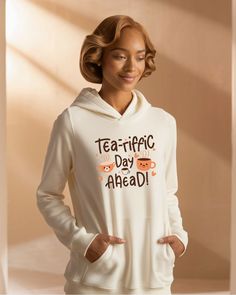 a woman wearing a white hoodie that says tea - free day ahead