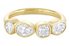 three stone diamond ring in yellow gold, with four diamonds on each side and two smaller stones