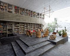 the interior of a library with stone steps leading up to it and bookshelves