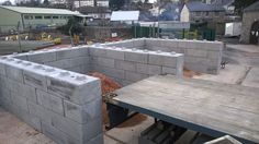 some concrete blocks are stacked on top of each other and ready to be placed in the ground