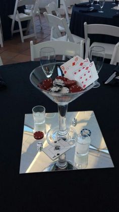 a table topped with two wine glasses and cards