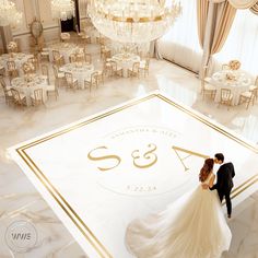 a bride and groom are standing on the dance floor in front of chandeliers