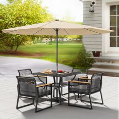 a patio table with chairs and an umbrella