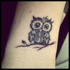 an owl tattoo on the wrist