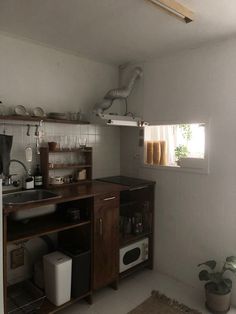 a kitchen with a sink, stove and microwave