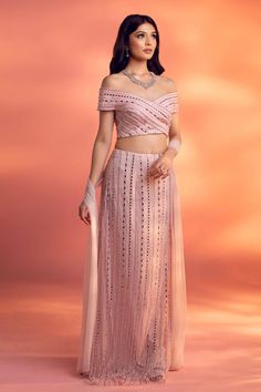 Pink straight skirt embellished with flat crystal beads, glass beads, and crystal drops over a net base.�Comes with embellished and padded off shoulder blouse and a dupatta.
Components: 3
Pattern: Embellished
Type Of Work: Flat crystal beads, glass beads, and crystal
Neckline: Off Shoulder
Sleeve Type: Short
Fabric: Net
Color: Pink
Other Details: 
Back cutout blouse
Attached lining
Approx. product weight: 1-2 Kgs
Occasion: Destination Wedding - Aza Fashions Straight Lehenga Skirt, Punjabi Lehenga, Pink Skirt Set, Western Blouse, Cutout Blouse, Embellished Skirt, Skirt Blouse, Embellished Flats, Skirt And Blouse