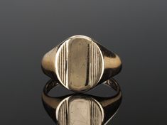 MENS SIGNET RING: 60s vintage gold ring, mid century modern mens or unisex jewellery. FREE SHIPPING. See specifications below.  A very stylish 1960s vintage minimalist gold ring with the full British hallmark for London dating it to 1967. It is 9k solid gold and has an oval signet with a striped detailing to the sides. The band is tapered and very slightly bevelled. There is a blank signet area for an initial to be engraved. This style of mens pinky rings from the 60s era harps back to the Art D Modern Oval 14k Stamped Signet Ring, Modern 14k Stamped Oval Signet Ring, Oval Modernist Signet Ring For Formal Occasions, Modernist Formal Signet Ring, Luxury Vintage Brass Signet Ring, Modernist Gold Signet Ring With Polished Finish, Modernist 14k Gold Signet Ring With Polished Finish, Luxury Antique Men's Signet Ring, Vintage Yellow Gold Signet Ring With Hallmarks