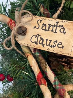 a santa clause ornament hanging from a christmas tree