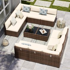 an outdoor living room with wicker furniture