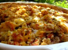 a casserole dish filled with rice and meat in a white bowl on top of a table