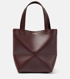 Find LOEWE Puzzle Fold Mini Leather Tote Bag on Editorialist. Material: calf leather. Lining: suede. Made in Spain. Designer color name: Dark Burgundy. Top handles, Detachable, adjustable shoulder strap. Comes with dust bag. Structured Leather Bucket Bag, Structured Calf Leather Bag, Structured Soft Calf Leather Bag, Luxury Leather Structured Bag, Structured Soft Leather Bags, Luxury Structured Leather Bag, Structured Leather Shoulder Bag With Leather Handles, Luxury Leather Structured Bucket Bag, Luxury Structured Leather Bucket Bag