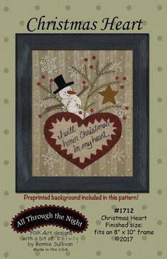 a cross stitch christmas heart with snowman on it