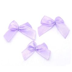 three small purple bows are shown on a white background