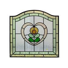 a stained glass window with a flower in the center and leaves on it's side