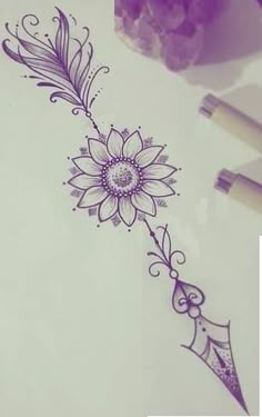 a drawing of a sunflower with an arrow on it's side next to some pens