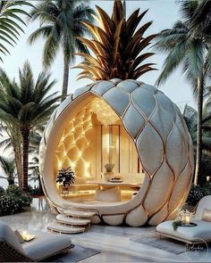 a large white pineapple shaped room in the middle of palm trees