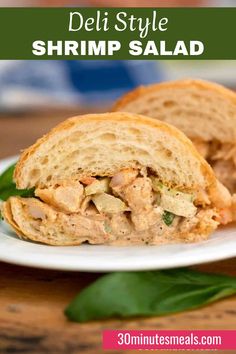 a close up of a sandwich on a plate with the words deli style shrimp salad