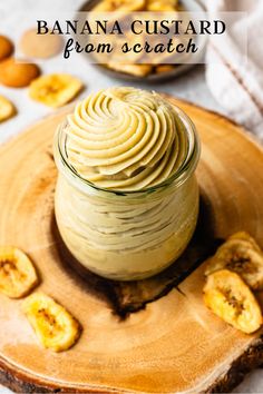 a wooden plate topped with banana slices next to a jar of peanut butter