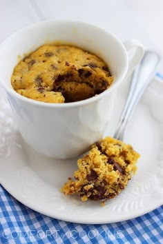 a white plate topped with a bowl of oatmeal and chocolate chip cookies