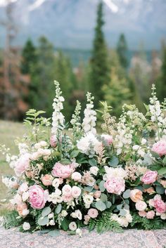 flowers and greenery are arranged on the ground