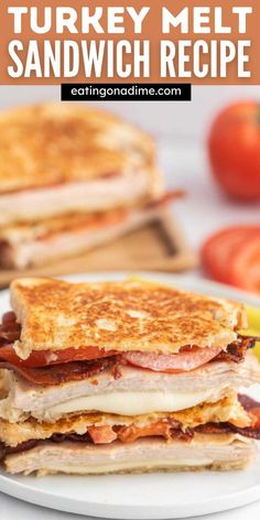 turkey melt sandwich recipe on a white plate with tomatoes and lemons in the background