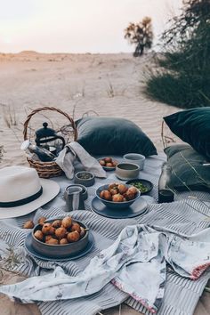 a table with food on it in the sand