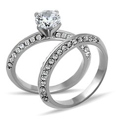 two wedding rings with diamonds on each side and an engagement ring in the middle,