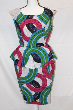 This beautiful Gown is made from pure African print. The gown is lined and fitted with zipper. good for work and any classy events  * 100% Cotton, no stretch * Handmade  * Length: 40"  SIZING https://buymych.com/sizing Kindly review size chart before making a purchase. Size chart is available. We recommend going up a size if you are in between sizes.  FABRIC CARE Note that our African Prints do not stretch.  DO NOT BLEACH. Machine wash SEPARATELY.  Warn iron on the wrong Side. Multicolor Peplum Dress For Party, Multicolor Fitted Peplum Dress, Fitted Sleeveless Dress With Colorful Pattern, Colorful Pattern Fitted Sleeveless Dresses, Fitted Green Dress With Geometric Pattern, Fitted Patterned Dresses With Geometric Design, Fitted Dress With Geometric Pattern, Fitted Sleeveless Patterned Dress, Fitted Multicolor Dress With Geometric Pattern