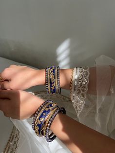 These heavy designer bangles are glamorous, providing a statement for any occasion. They are quite durable, not easily bendable. Designed with opulence in mind, these exquisitely designed bangles set on a velvet base will complement a range of Indian outfits. Perfect for gifts.  Quantity: Pair of 5 for each hand (Total: 10 pieces) Material: Fine Quality Metal with Gold Plating, Pearl/Jewels Beading, and Velvet Base **ALSO available in Maroon Red. Please see our listings Blue Traditional Bangle For Festive Occasions, Traditional Blue Bangle For Weddings, Blue Bangle For Weddings And Festivals, Traditional Blue Wedding Bangle, Blue Wedding Bangle For Festive Occasions, Blue Festive Wedding Bangle, Festive Blue Wedding Bangle, Festive Blue Bangle Jewelry, Festive Blue Bangle For Festivals